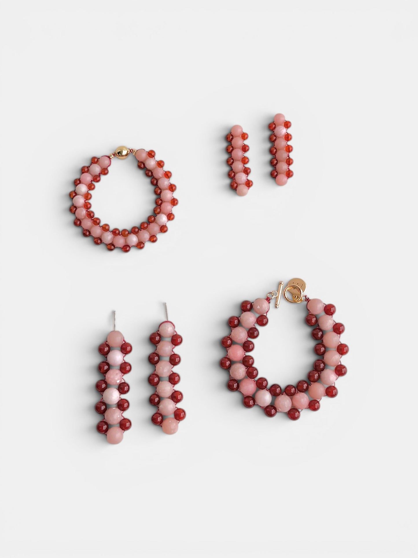Hollywood Road Stories handcrafted beaded drop earrings and bracelets in pink and red matte and translucent beads.