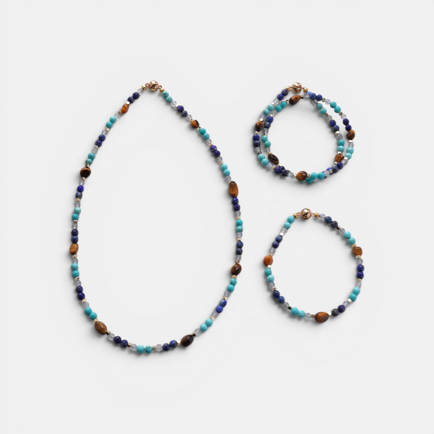 Hollywood Road Stories beaded gemstone jewelry set featuring turquoise, lapis lazuli, and tiger's eye with gold clasp