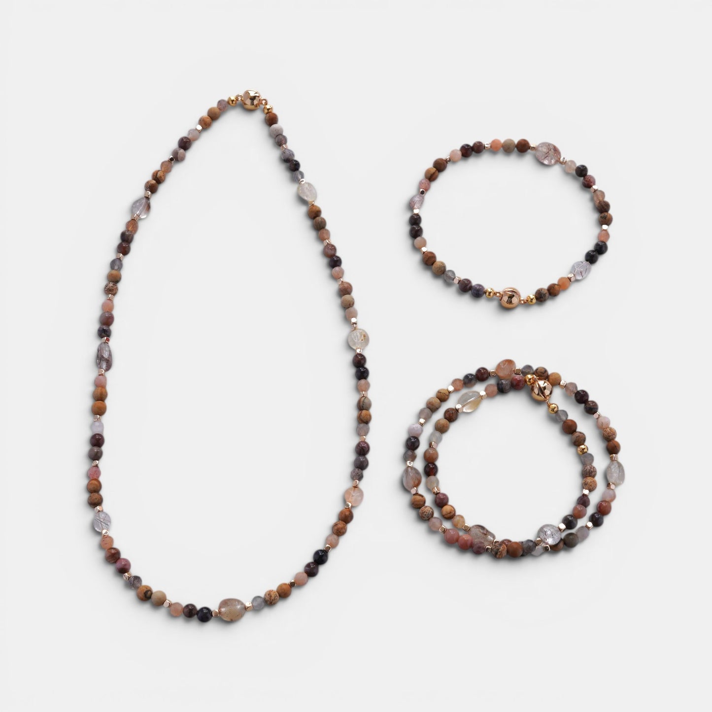 Hollywood Road Stories beaded gemstone necklace and bracelet set with brown, pink, and quartz stones and gold accents.
