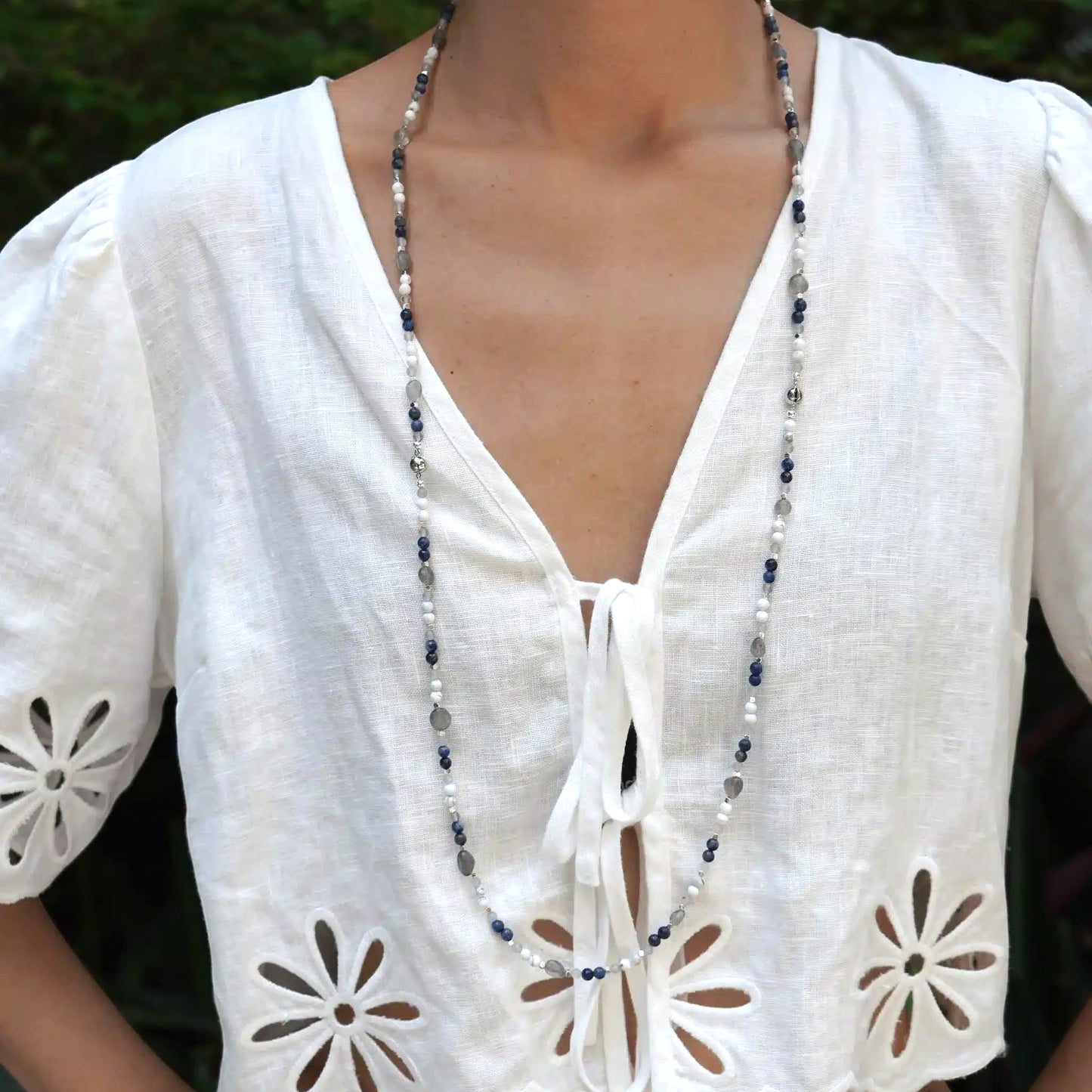 Hollywood Road Stories long beaded necklace with white howlite, blue lapis lazuli, and labradorite on a model