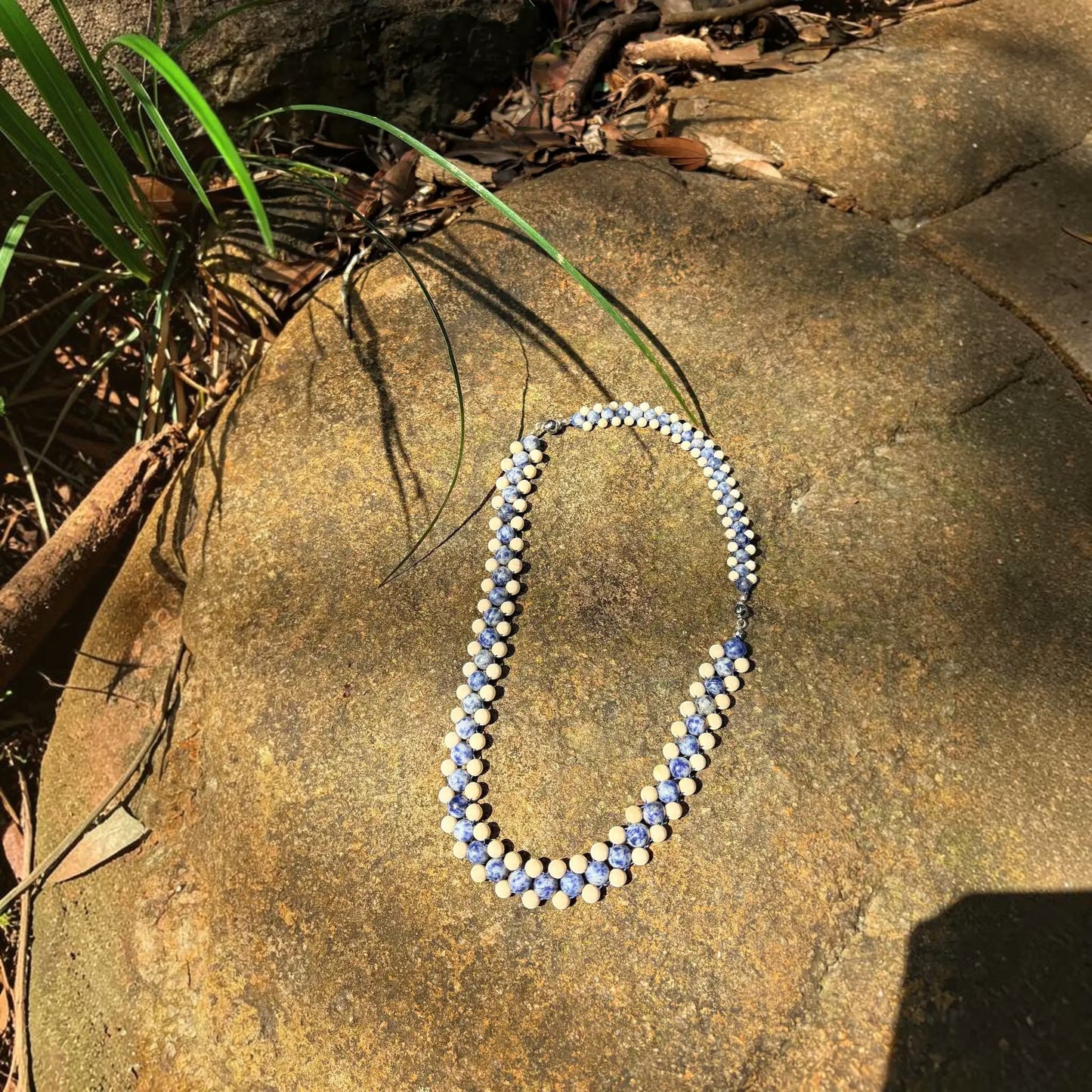 Hollywood Road Stories Aberdeen blue sodalite and cream jasper beaded choker necklace on a natural stone background