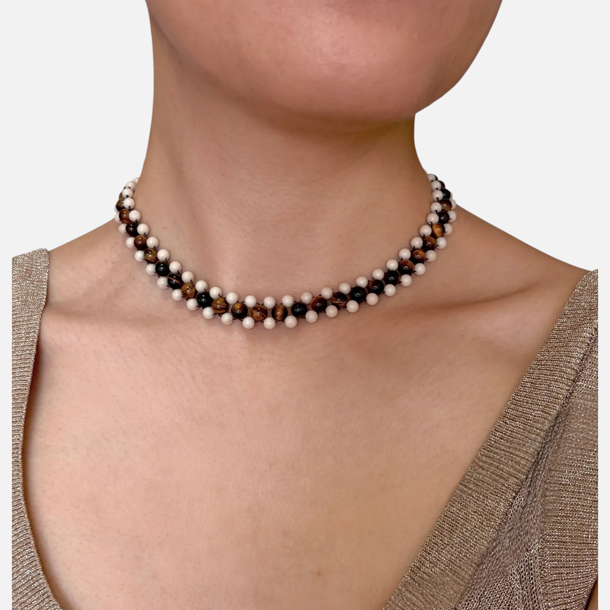Hollywood Road Stories handcrafted beaded necklace featuring alternating tiger's eye and cream jasper beads on a model.