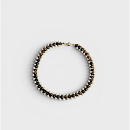Hollywood Road Stories handcrafted statement necklace featuring alternating tiger's eye and white beads with gold clasp.
