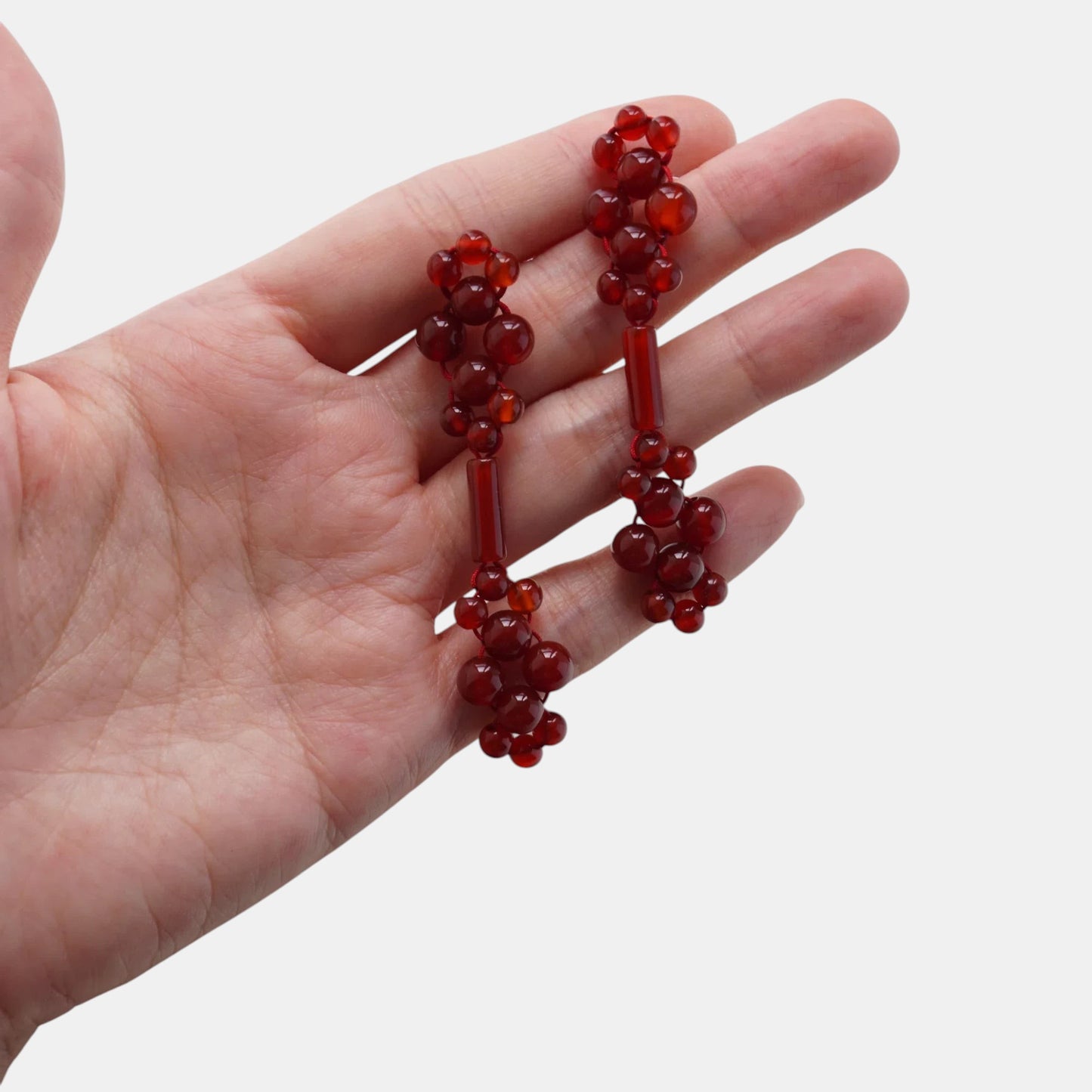 Hollywood Road Stories handcrafted red beaded drop earrings with polished round beads and elongated bar accents.