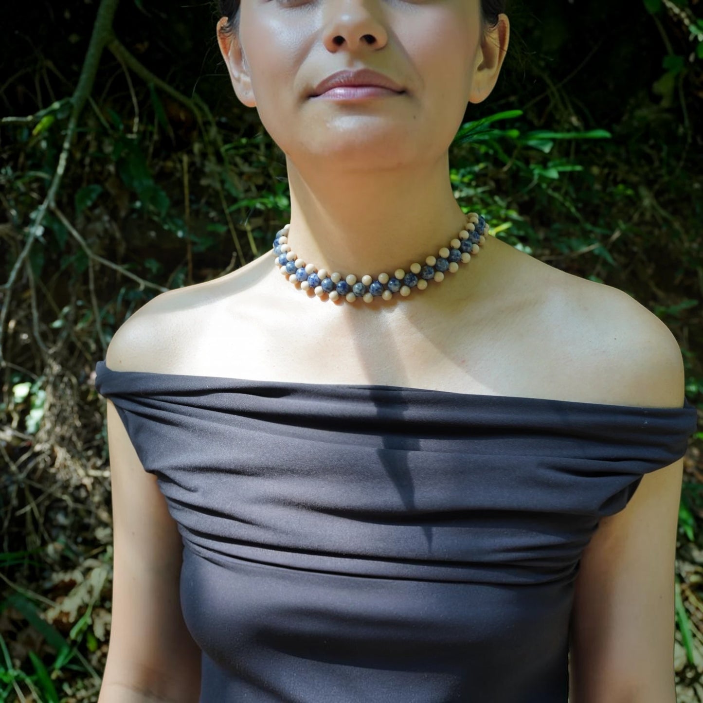 model wearing crystal necklace in nature, made by Hollywood Road Stories