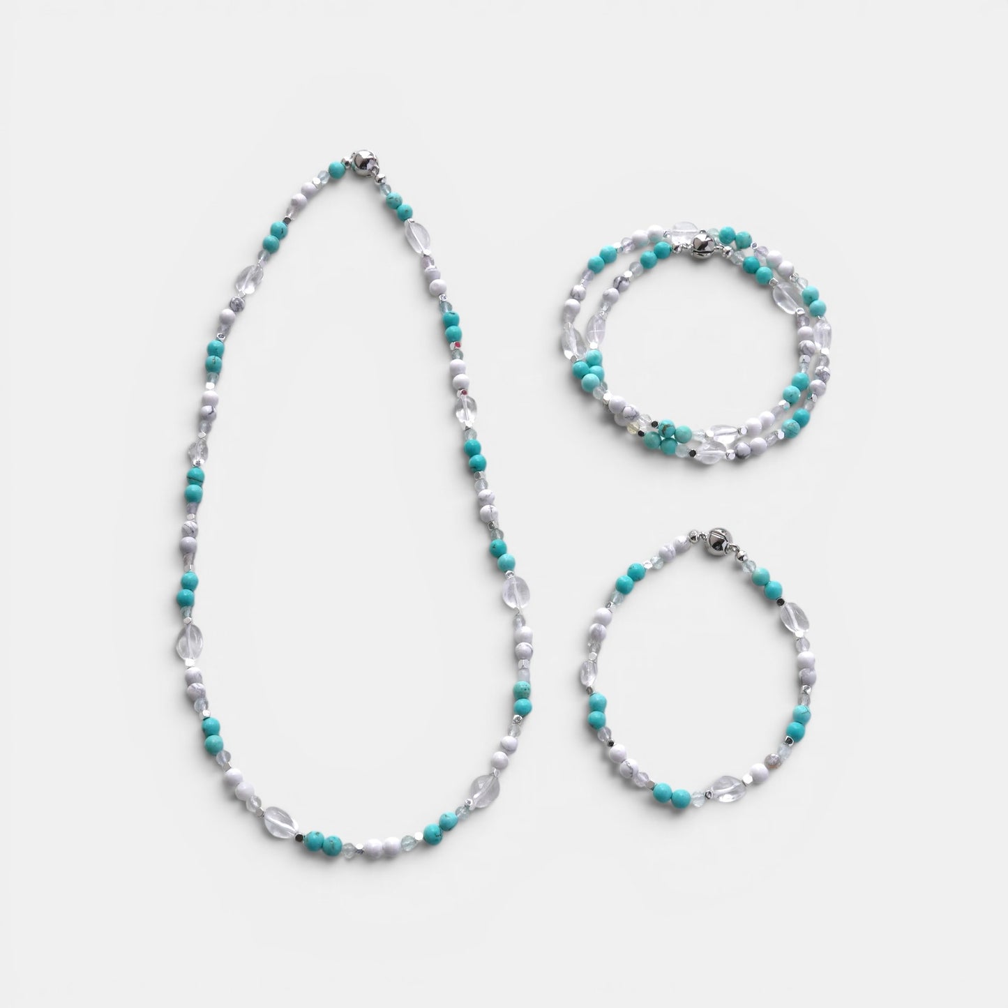 Hollywood Road Stories beaded necklace and two matching bracelets with turquoise, white, and clear crystal beads.