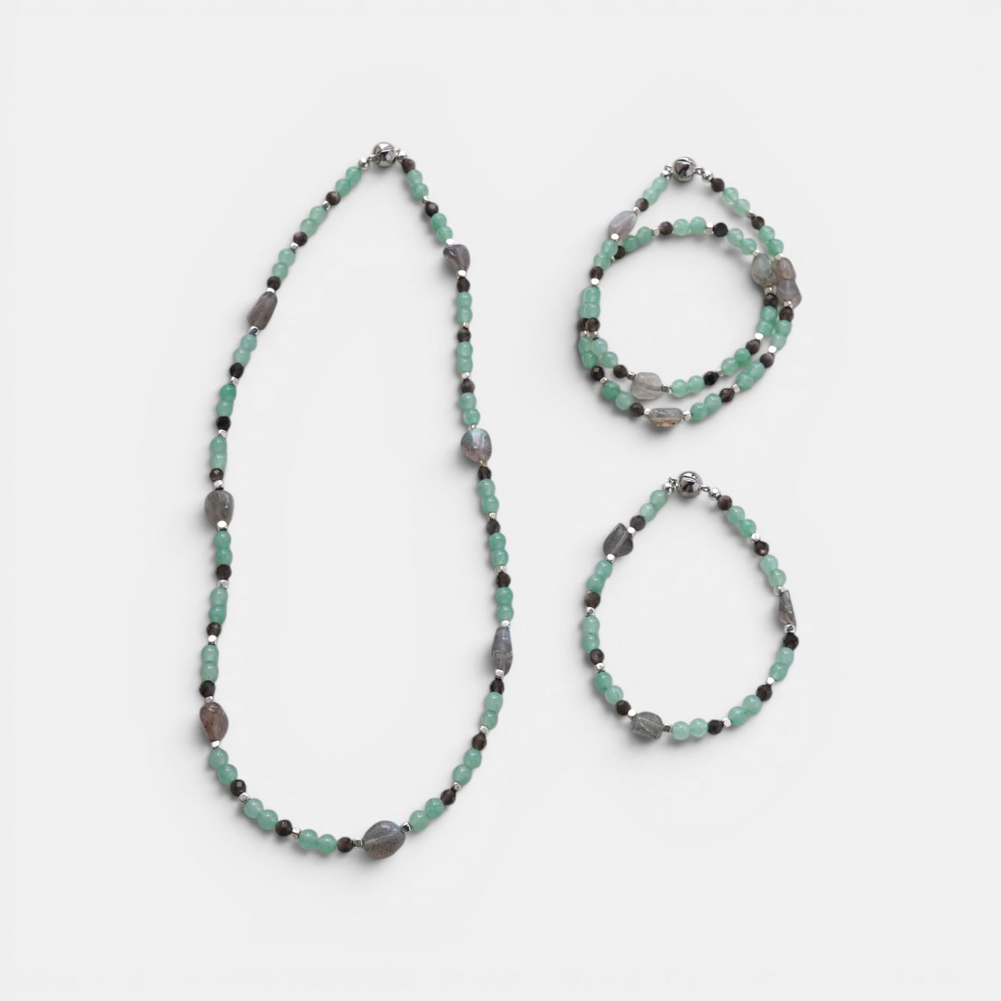 Hollywood Road Stories mint green and grey beaded necklace and bracelet set with metallic accents on a white background