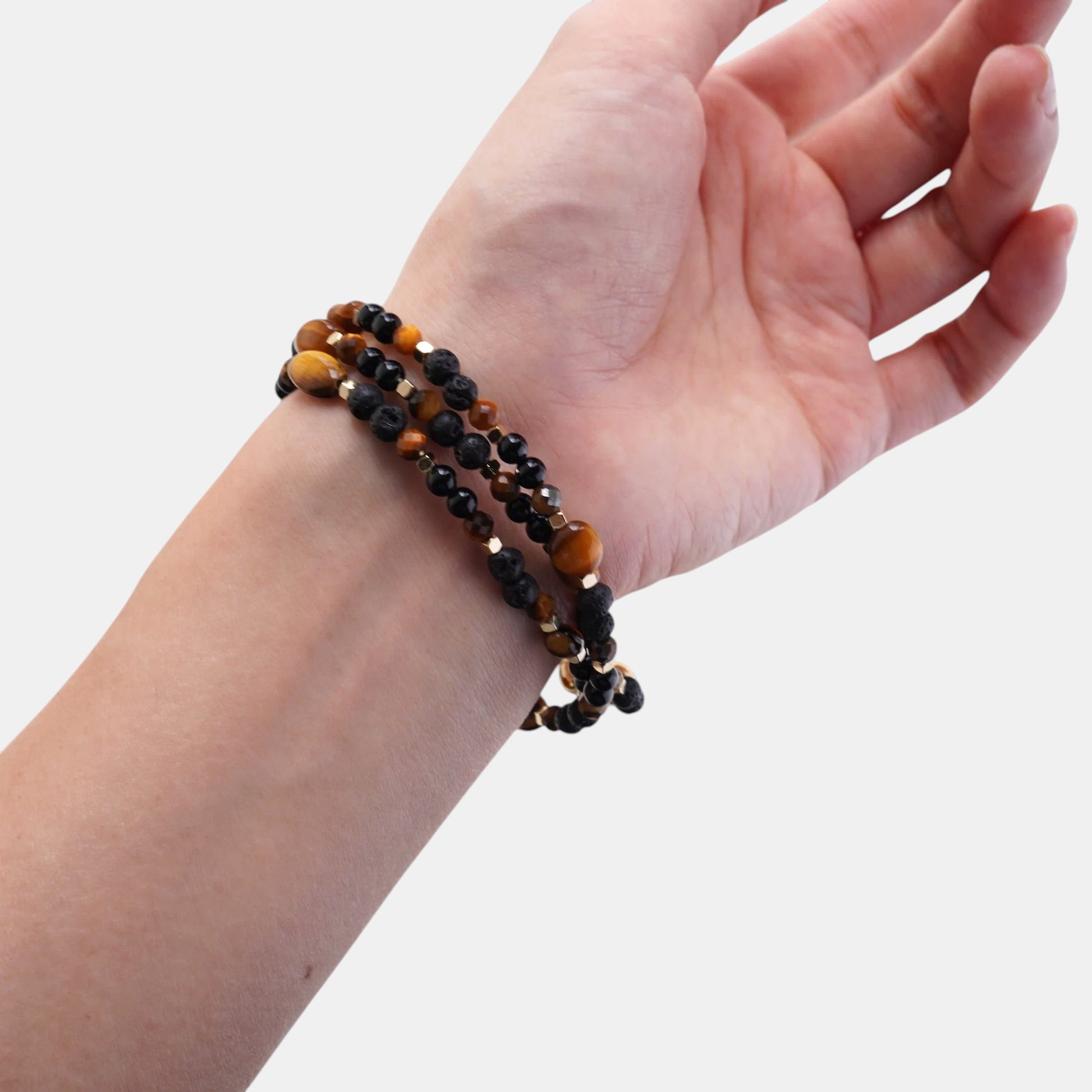 Hollywood Road Stories layered beaded bracelet with black onyx and tiger eye stones on a wrist