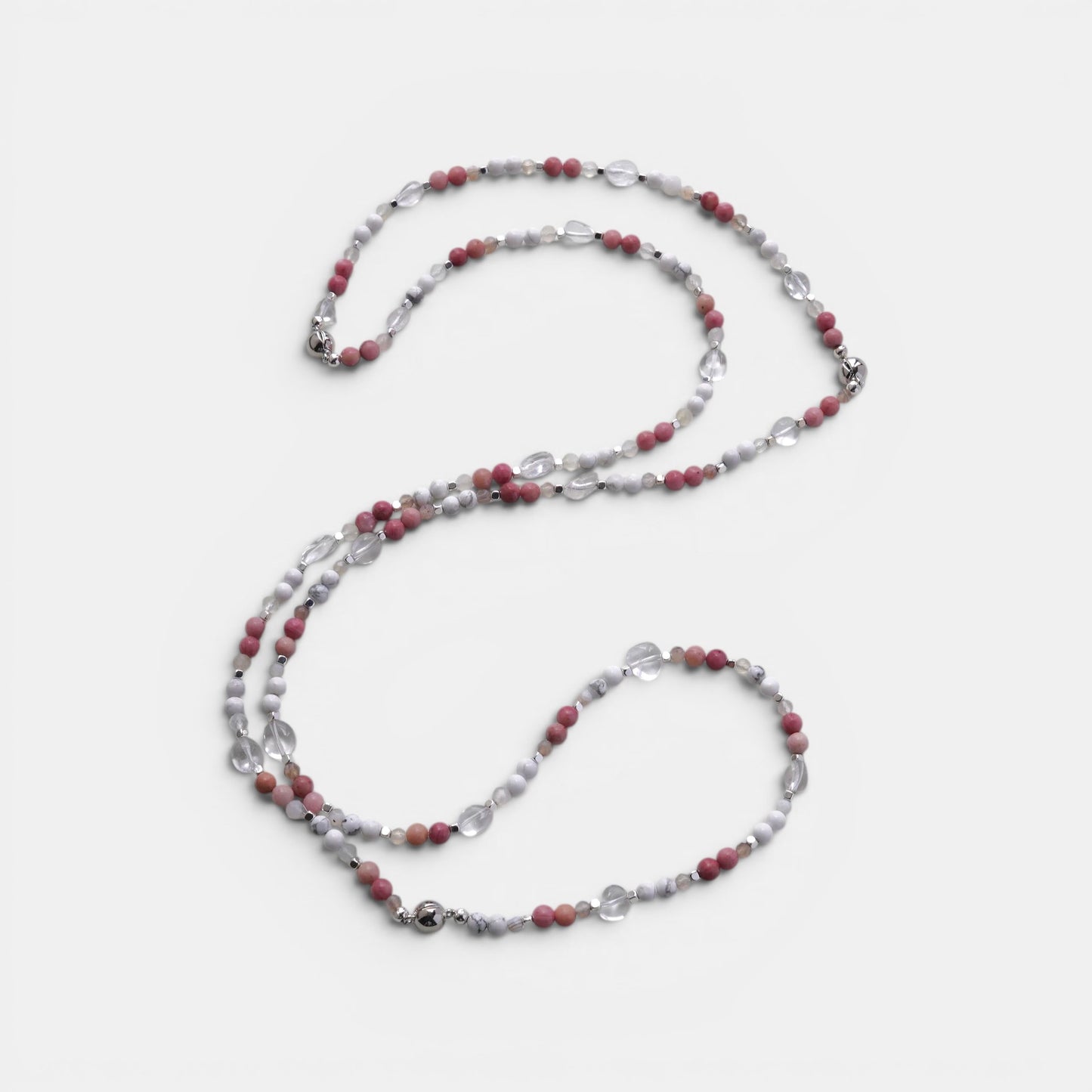 Hollywood Road Stories layered necklace with pink rhodonite, white howlite, and clear crystal beads on a light background