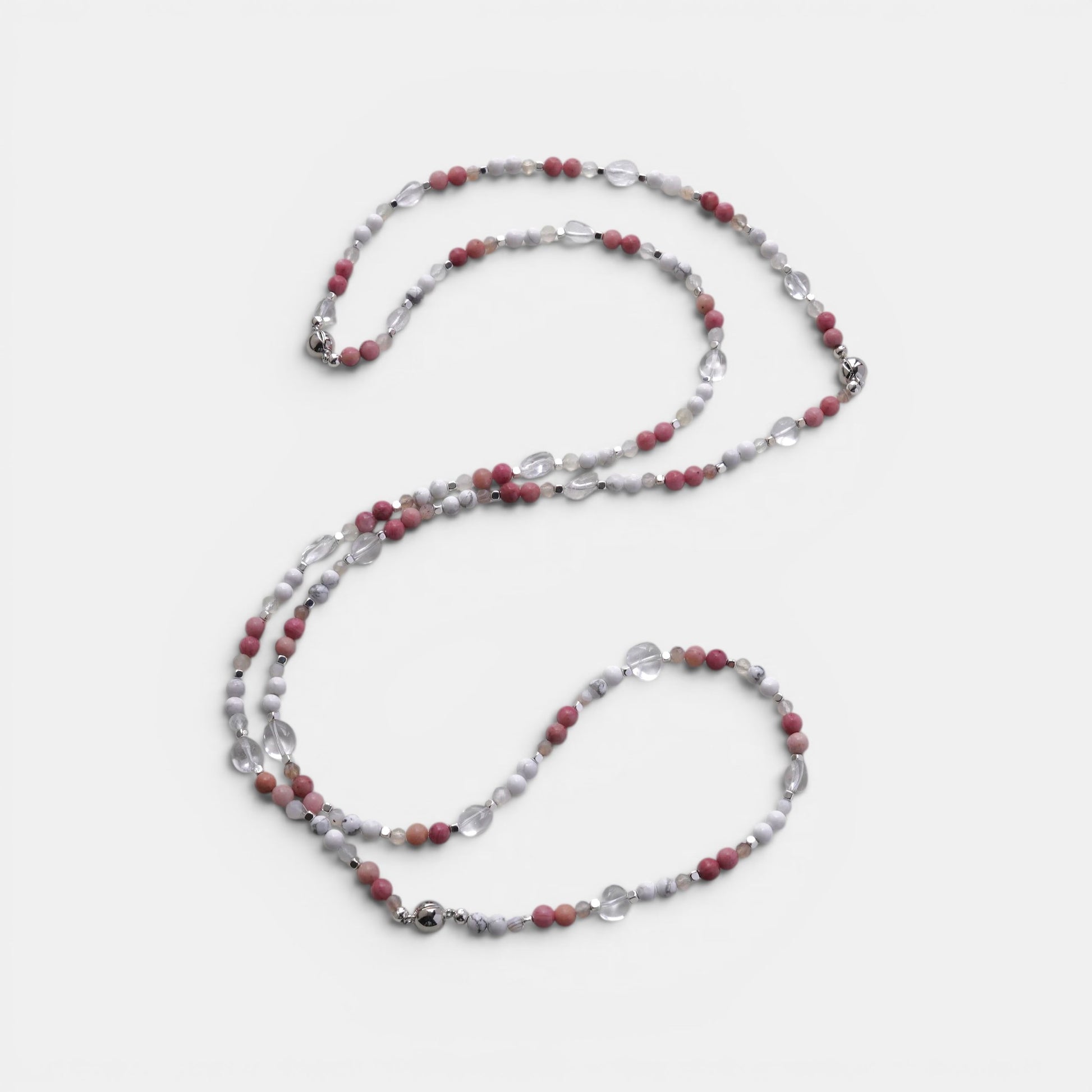 Hollywood Road Stories layered necklace with pink rhodonite, white howlite, and clear crystal beads on a light background