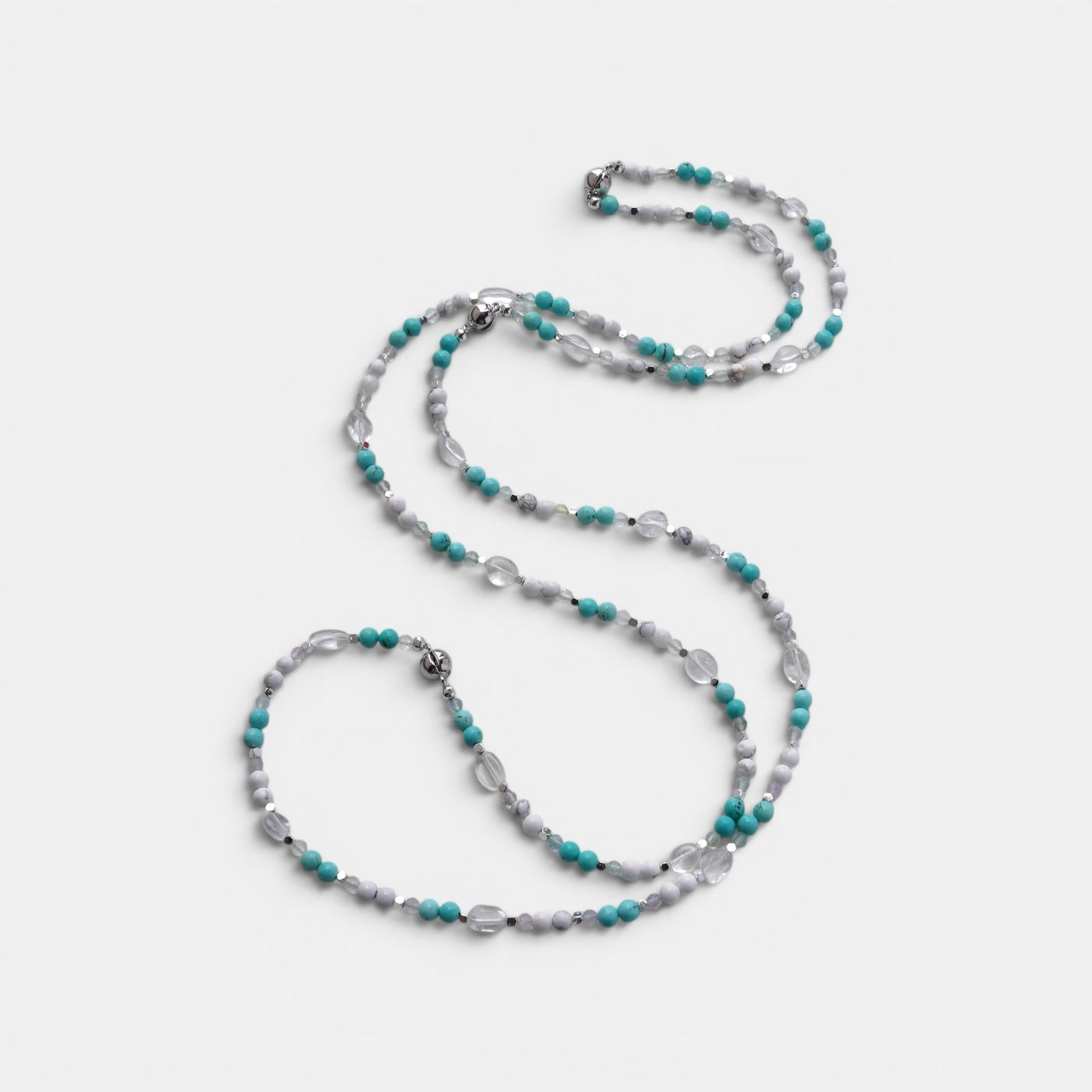 Hollywood Road Stories multi-strand beaded necklace with turquoise, white, and clear crystal beads and silver spacers.