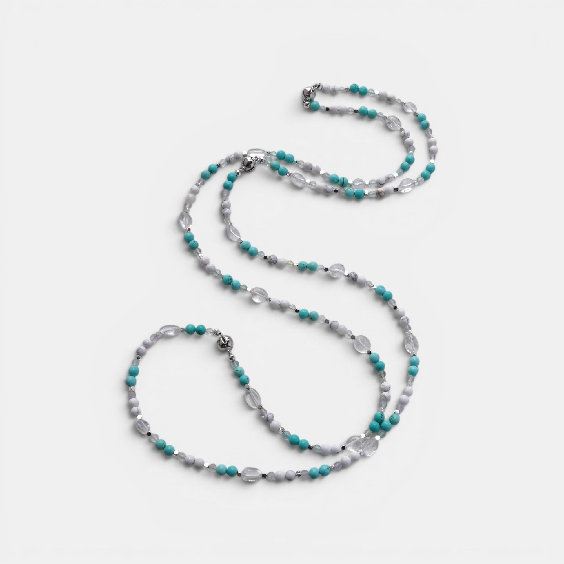 Hollywood Road Stories multi-strand beaded necklace with turquoise, white, and clear crystal beads and silver spacers.