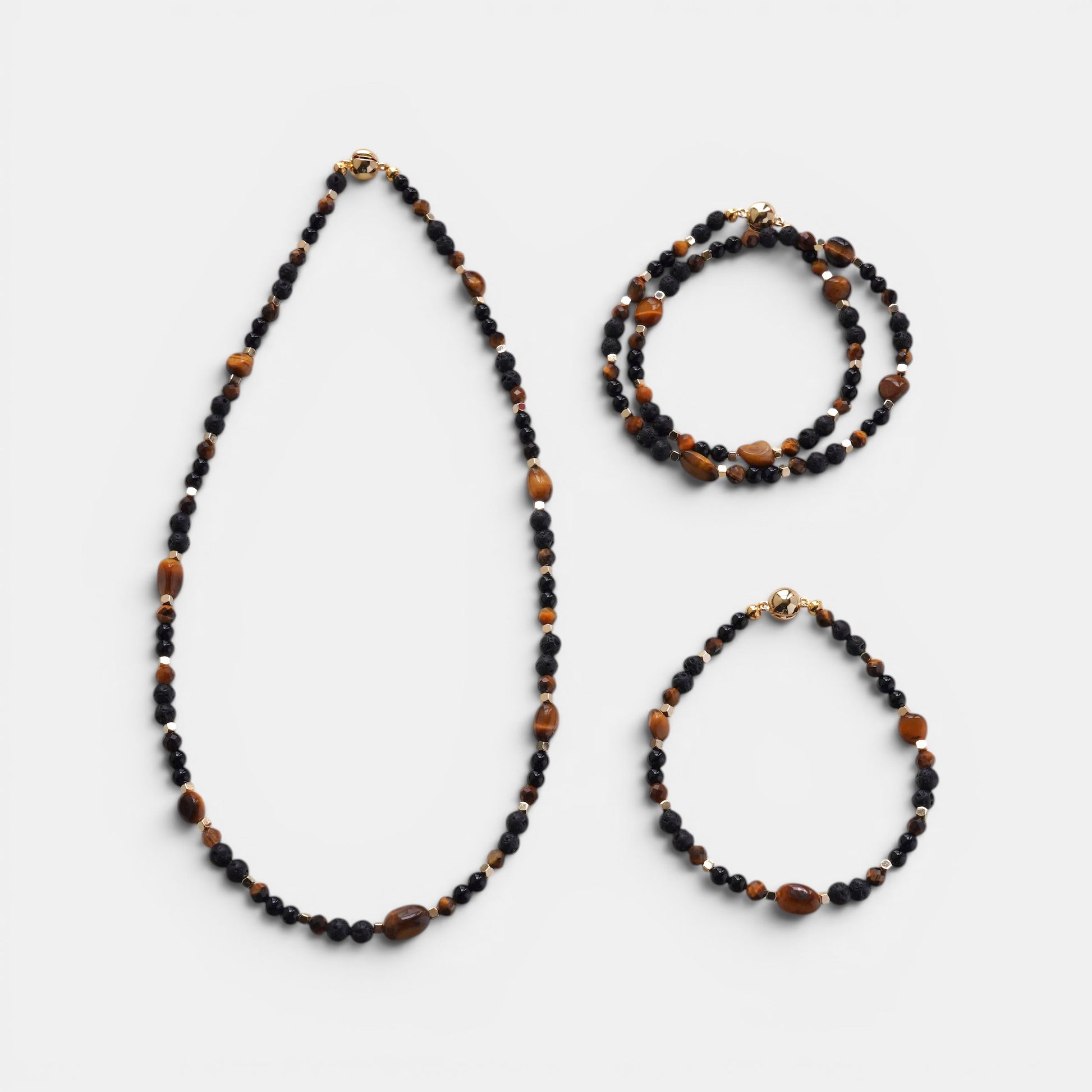 Hollywood Road Stories beaded necklace and bracelet set featuring black onyx and tiger eye stones with gold accents.