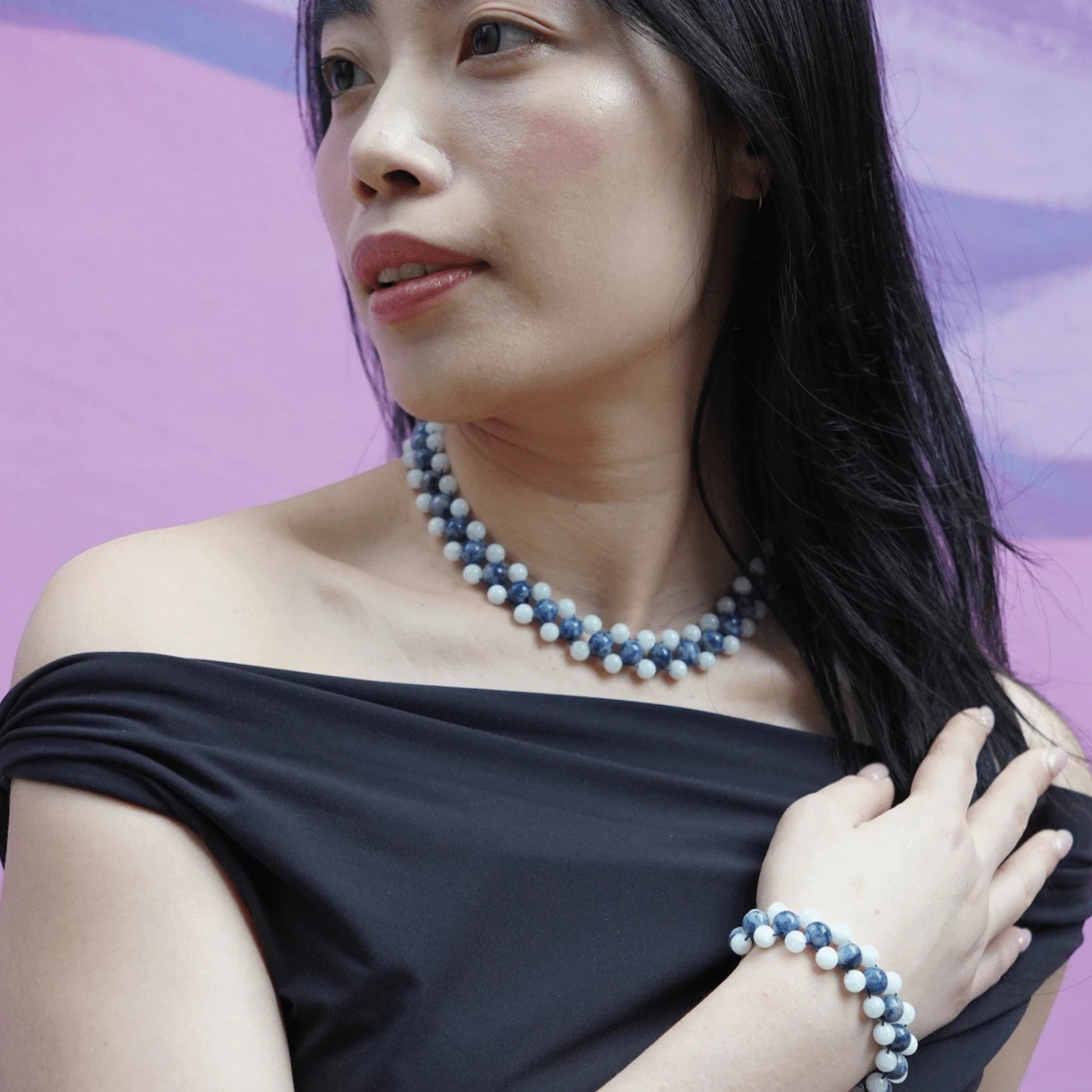 Hollywood Road Stories handcrafted blue and white marbled beaded necklace and matching bracelet on a model