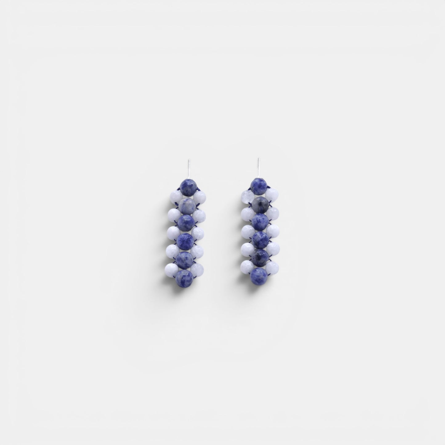 Hollywood Road Stories handcrafted statement earrings with blue marbled sodalite and matte white beaded columns.