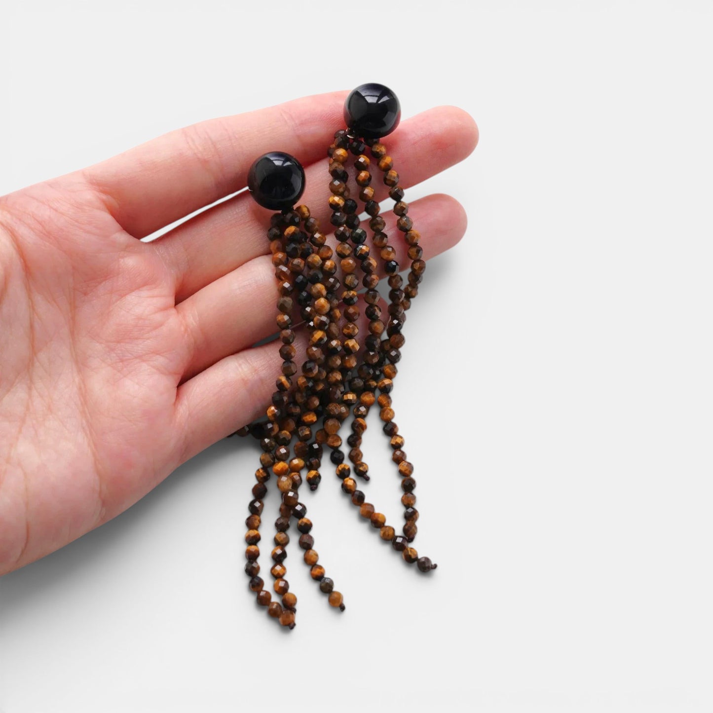 Hollywood Road Stories beaded tassel earrings with faceted tiger's eye strands and polished black onyx studs.
