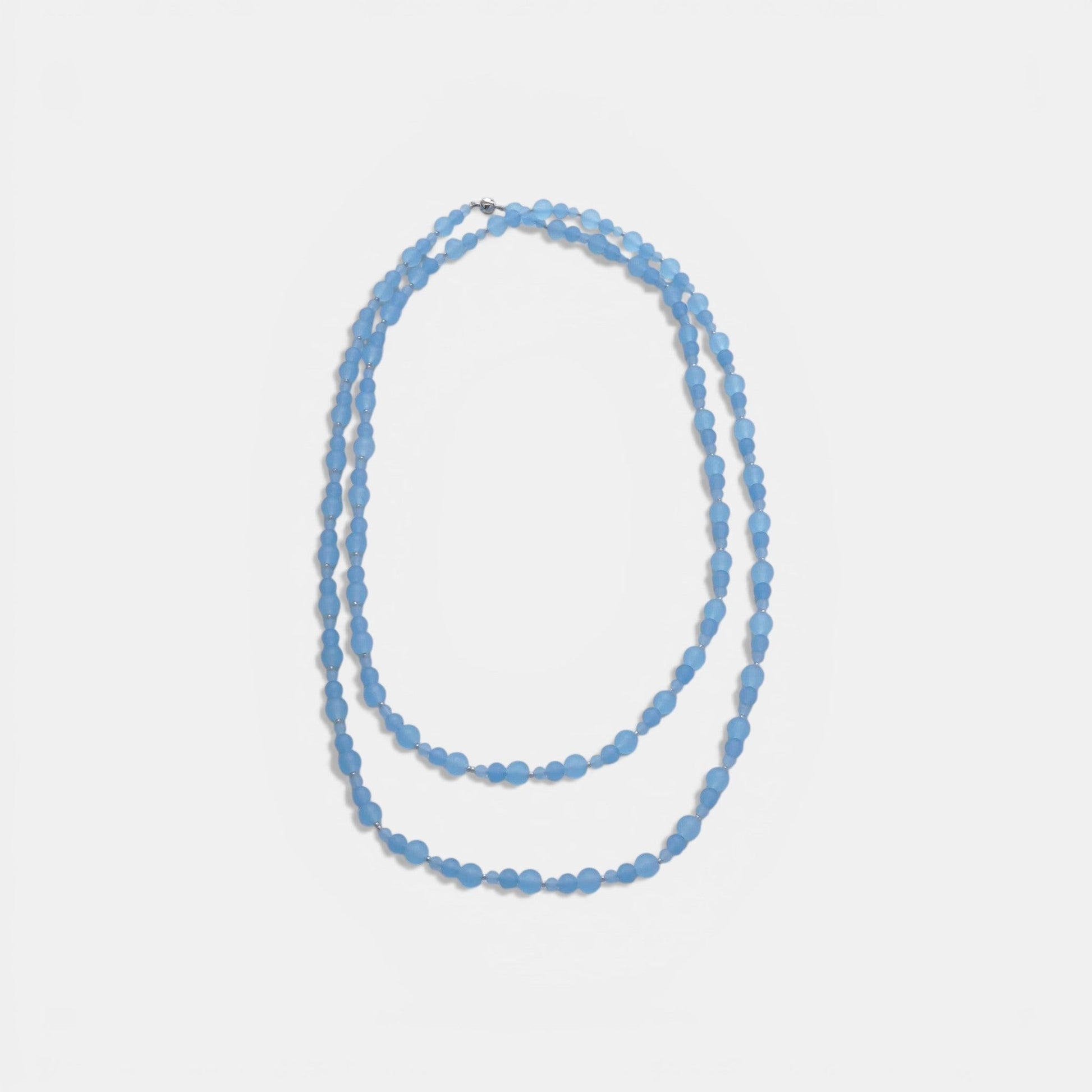 Hollywood Road Stories triple-strand frosted sky blue glass bead necklace with silver-toned spacers on a white background
