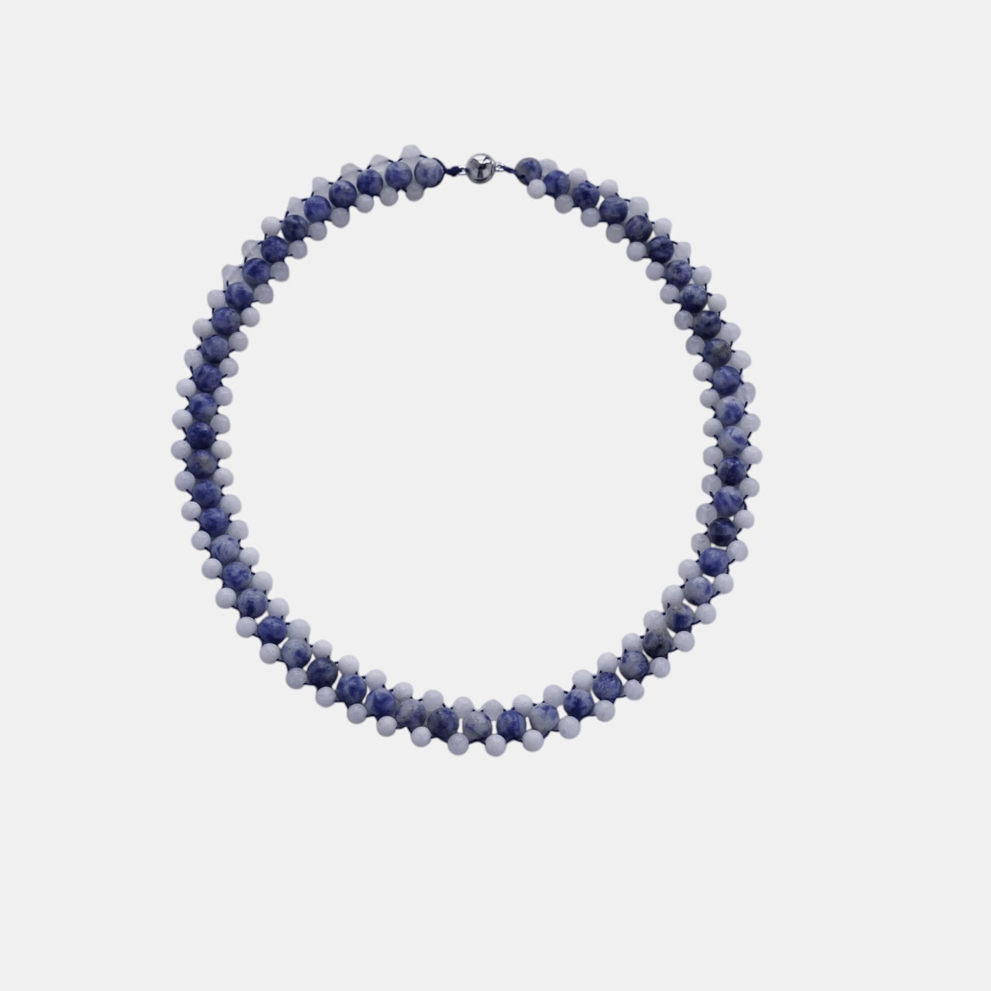 Hollywood Road Stories handcrafted double-strand beaded necklace with blue marbled and white beads on a grey background.