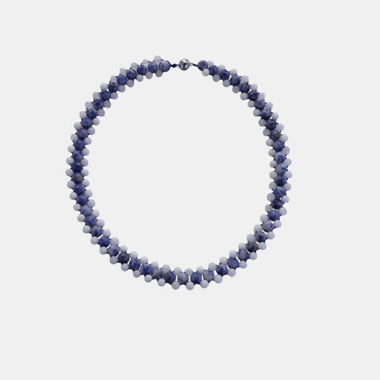 Hollywood Road Stories handcrafted double-strand beaded necklace with blue marbled and white beads on a grey background.