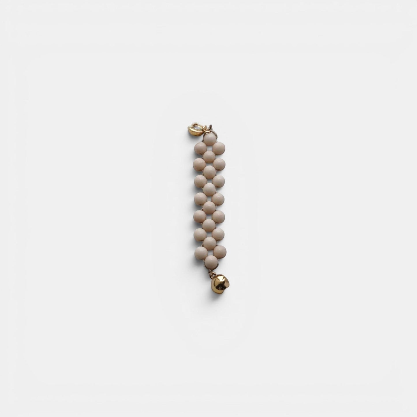Hollywood Road Stories multi-strand cream beaded bracelet with gold-toned hardware and a small polished gold charm.