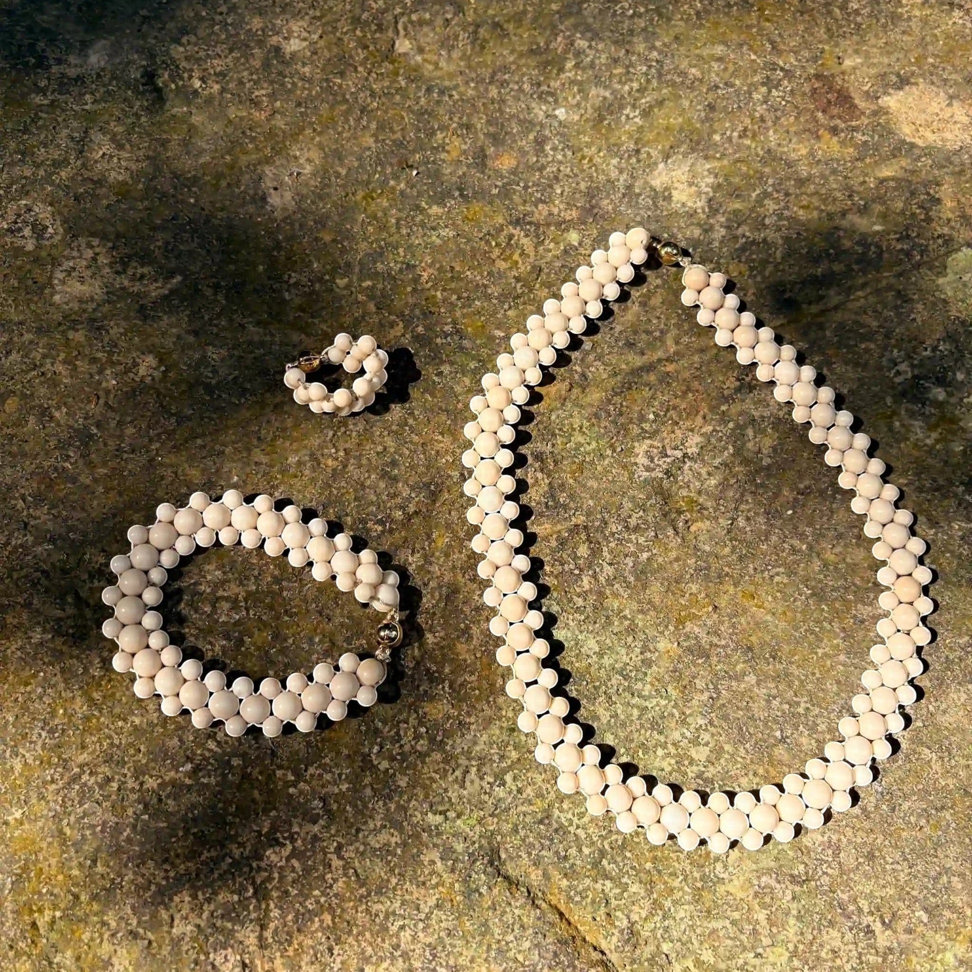 Hollywood Road Stories cream beaded jewelry set featuring a multi-strand necklace, matching bracelet, and ring.
