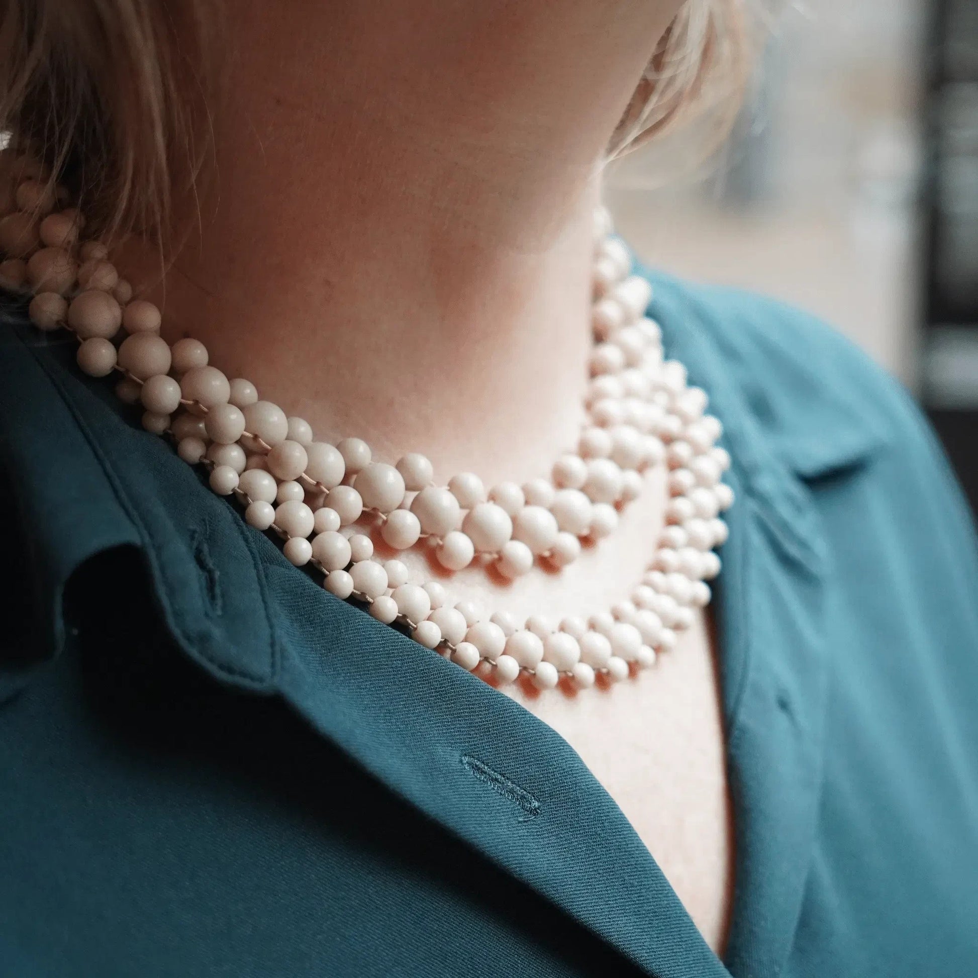 Hollywood Road Stories double strand cream beaded necklace worn with a teal blouse