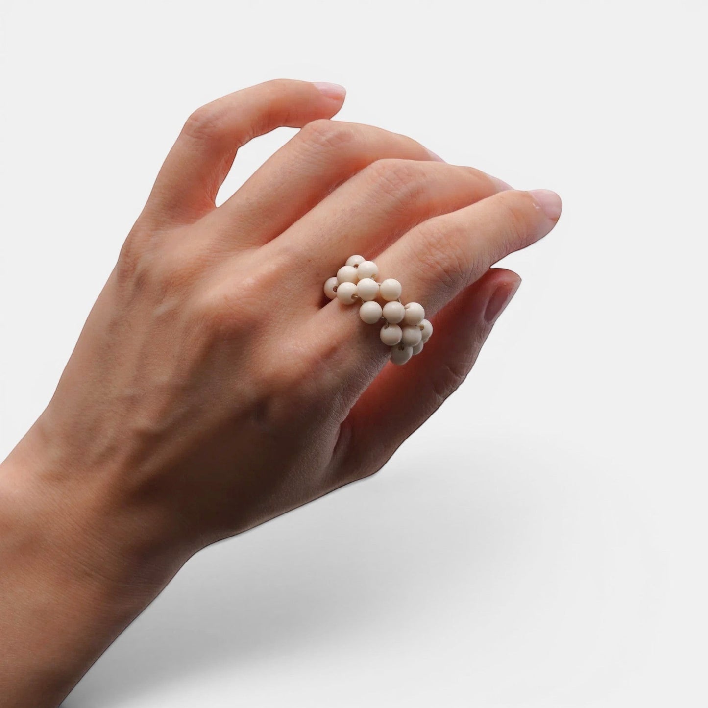 Hollywood Road Stories cream matte beaded ring worn on a woman's finger against a neutral background