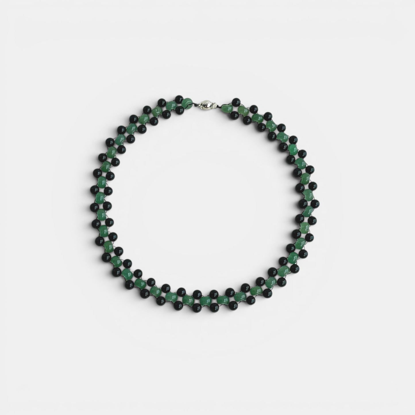Hollywood Road Stories double strand choker necklace featuring green jade and black lava stone beads on a light background
