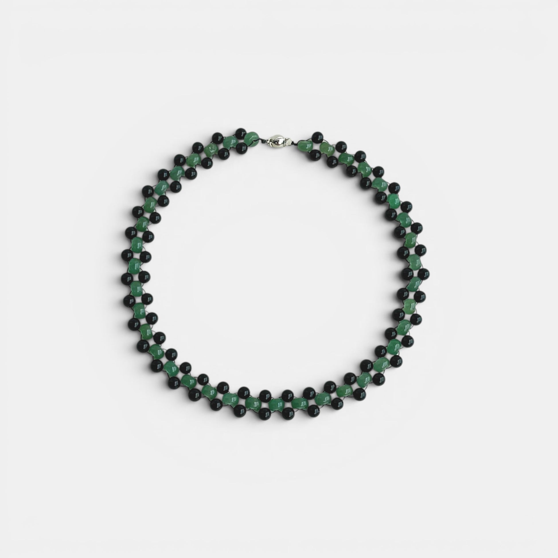 Hollywood Road Stories double strand choker necklace featuring green jade and black lava stone beads on a light background