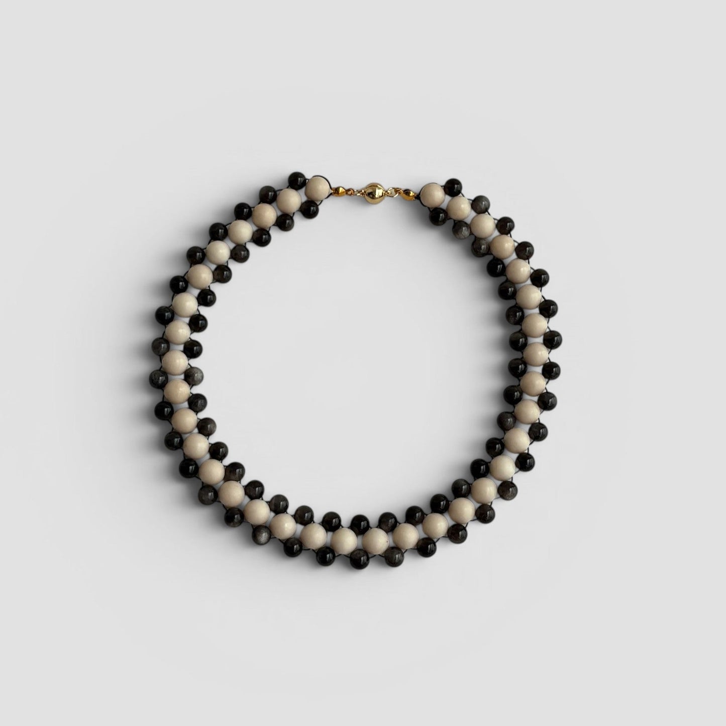 Hollywood Road Stories double strand necklace with alternating off-white and charcoal-black beads and gold-tone clasp.