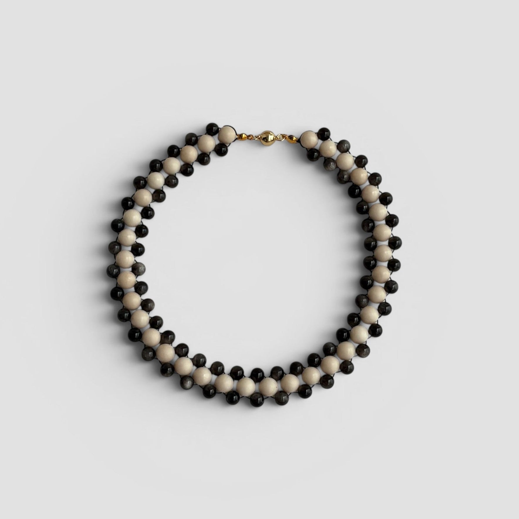 Hollywood Road Stories double strand necklace with alternating off-white and charcoal-black beads and gold-tone clasp.