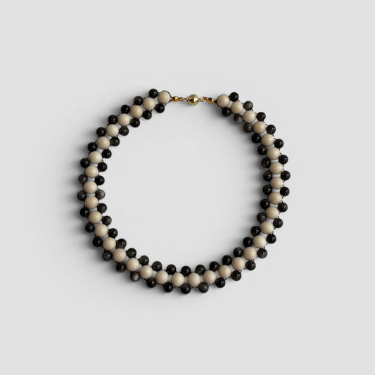 Hollywood Road Stories double strand necklace with alternating off-white and charcoal-black beads and gold-tone clasp.