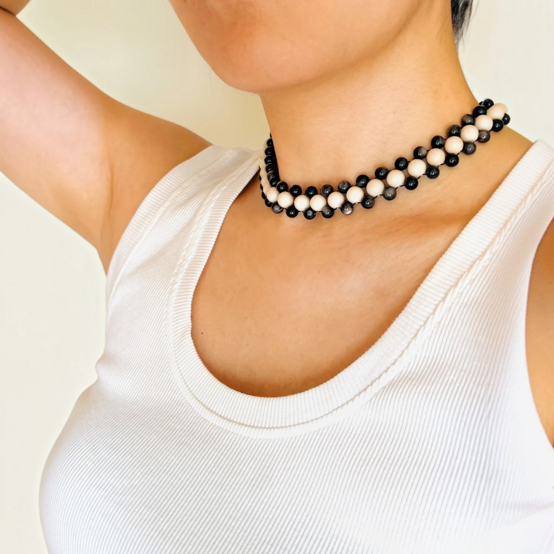 Hollywood Road Stories double strand beaded necklace with alternating off-white and charcoal-black beads on a model.