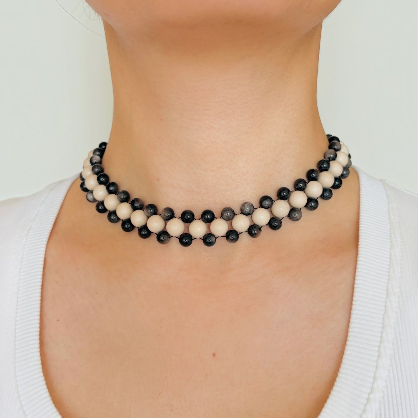 Hollywood Road Stories double strand beaded necklace with alternating off-white and charcoal-black beads on a model