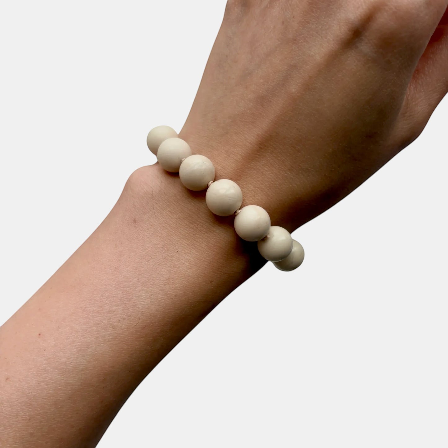 Hollywood Road Stories cream fossil jasper bead bracelet worn on a wrist, featuring a minimalist design.