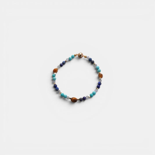 Hollywood Road Stories beaded bracelet with turquoise, lapis lazuli, and tiger's eye gemstones and a gold-tone clasp.