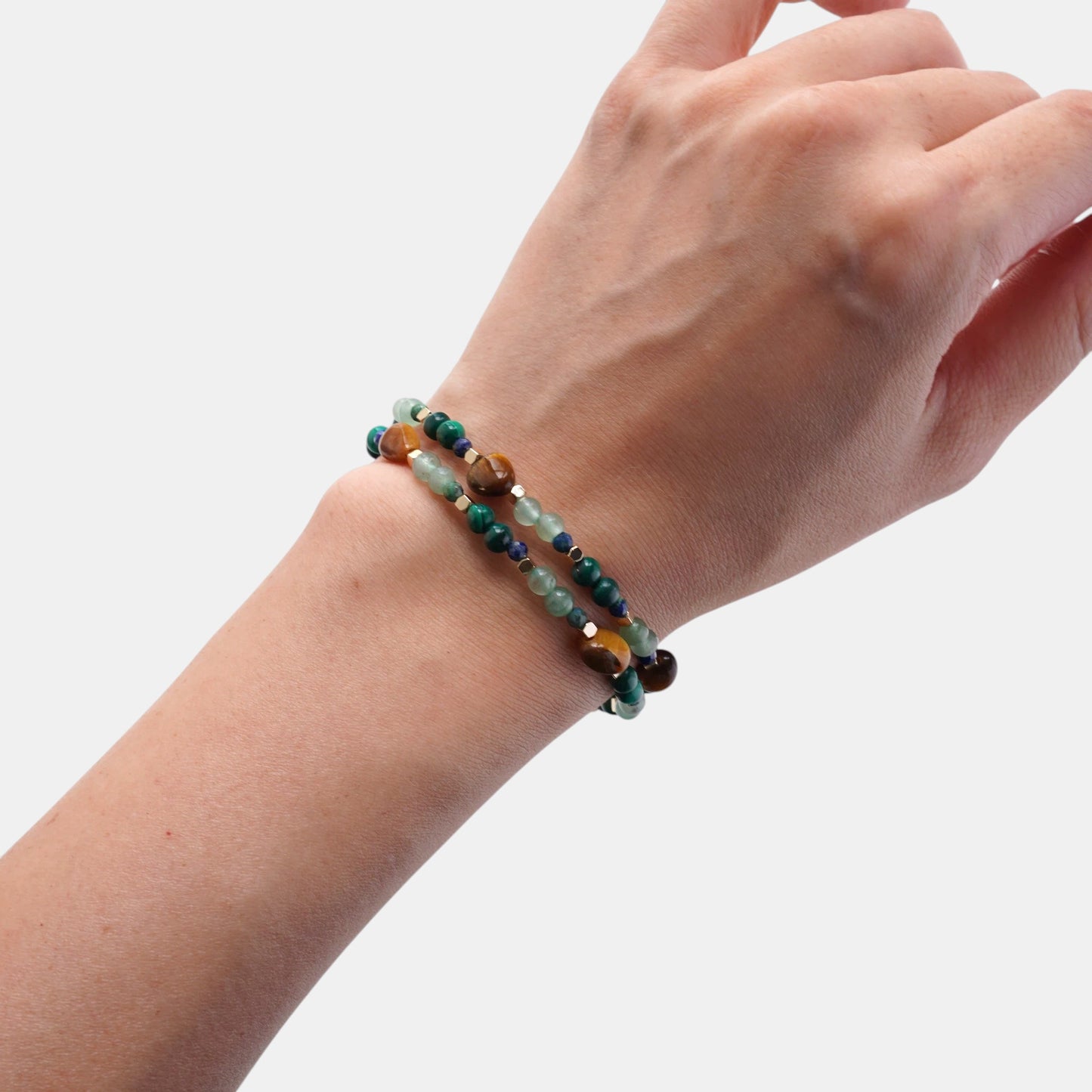 Hollywood Road Stories handcrafted gemstone bracelets featuring tiger's eye, malachite, and jade beads with gold spacers.