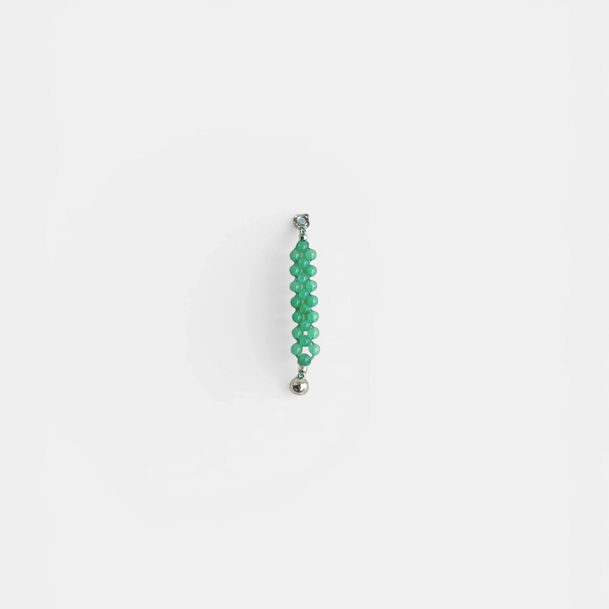 Hollywood Road Stories green beaded statement ring with silver-tone clasp on a white background.