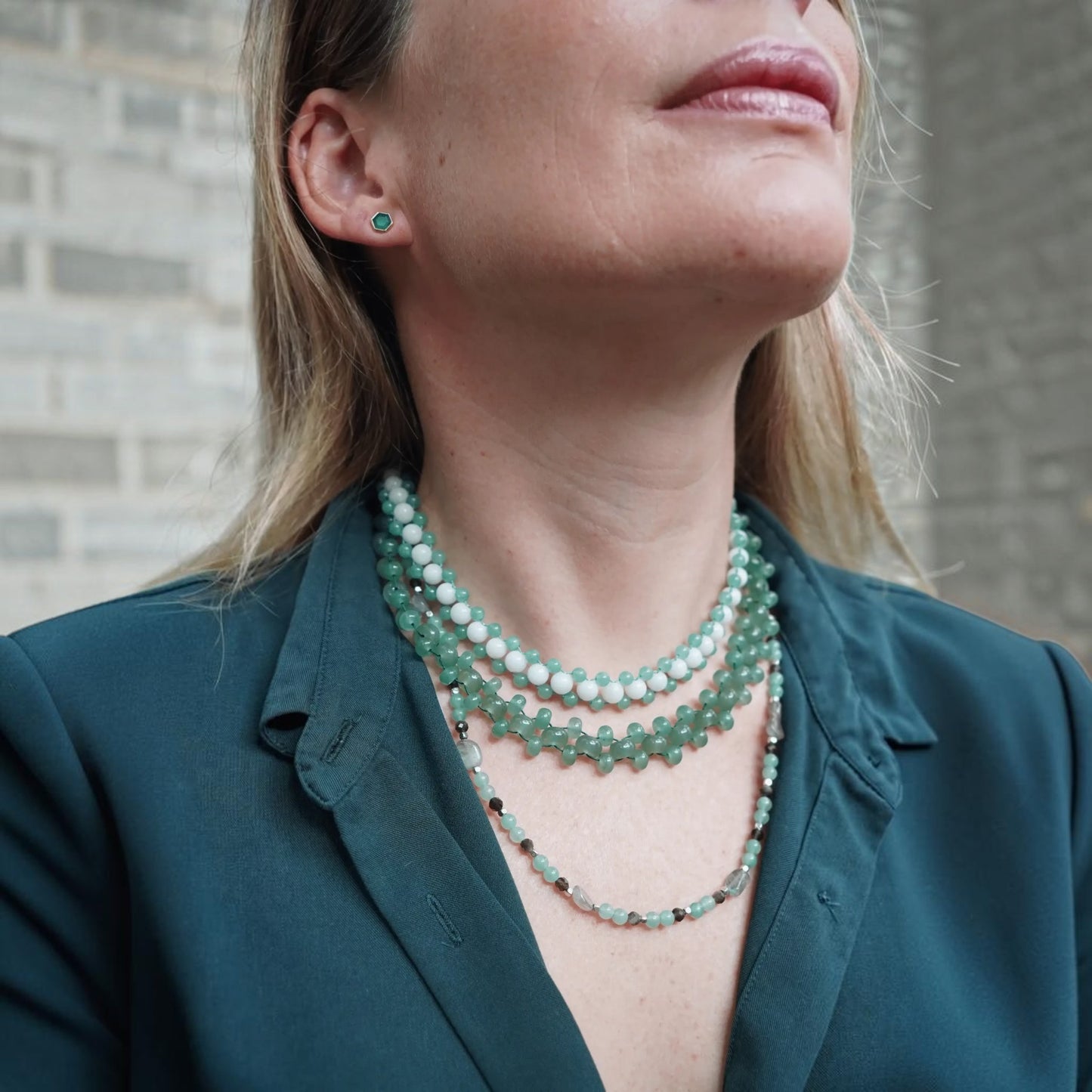 Hollywood Road Stories layered beaded choker necklace in sage green and white worn by a woman in a dark green shirt.