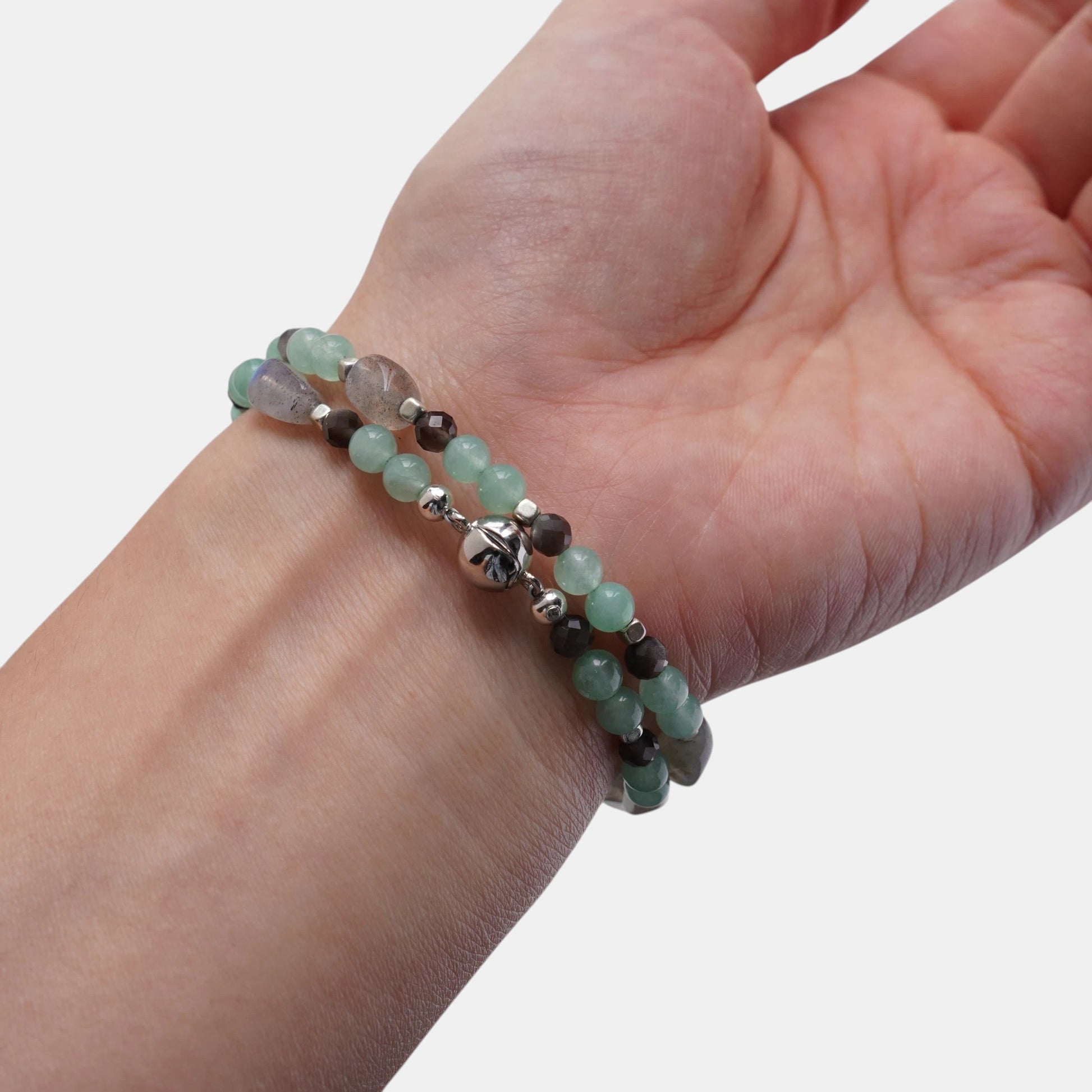 Hollywood Road Stories double-strand beaded bracelet with mint-green jade and grey gemstone beads on a wrist.