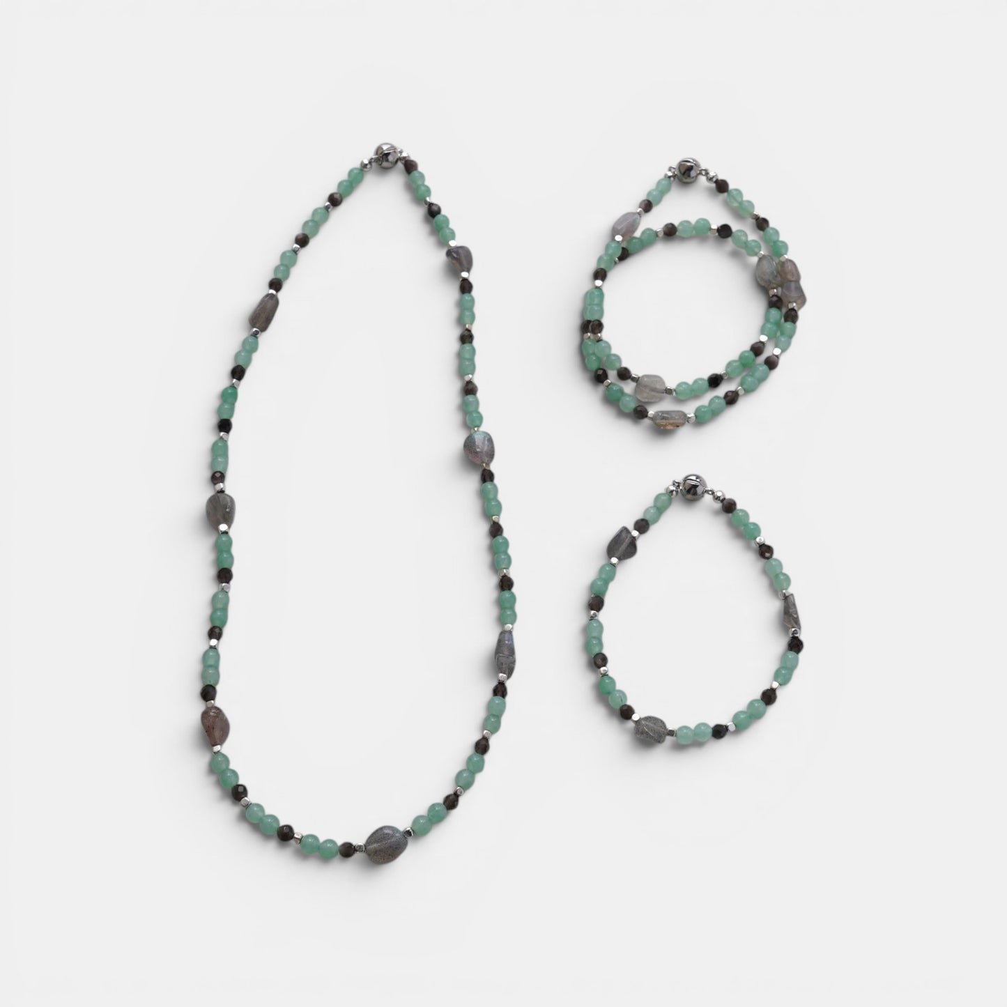 Hollywood Road Stories beaded jewelry set featuring mint-green jade and grey gemstone beads with metallic spacers.