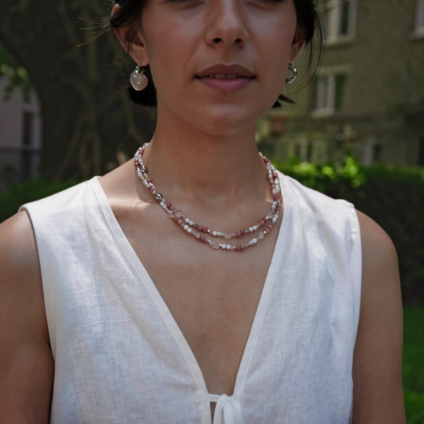 Hollywood Road Stories layered beaded necklace with pink rhodonite, white howlite, and clear crystal beads on a model.