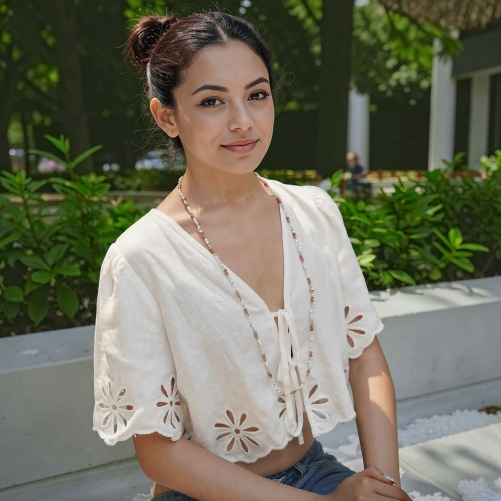 Hollywood Road Stories layered beaded necklace with pink rhodonite and white howlite worn by a woman in a white top.