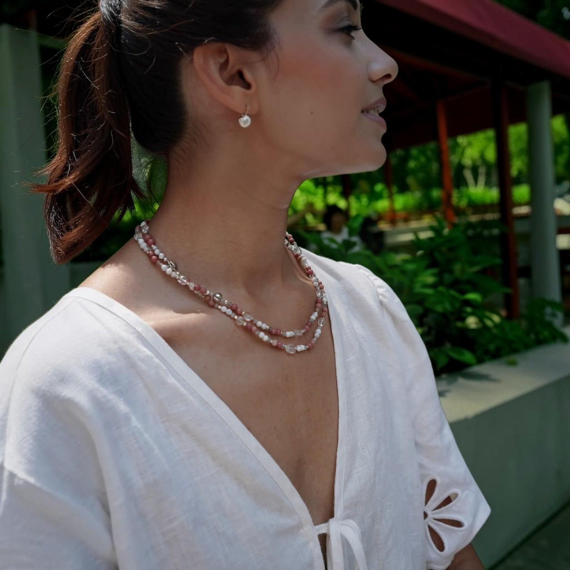 Hollywood Road Stories layered beaded necklace with pink rhodonite, white howlite, and crystal beads on a woman.
