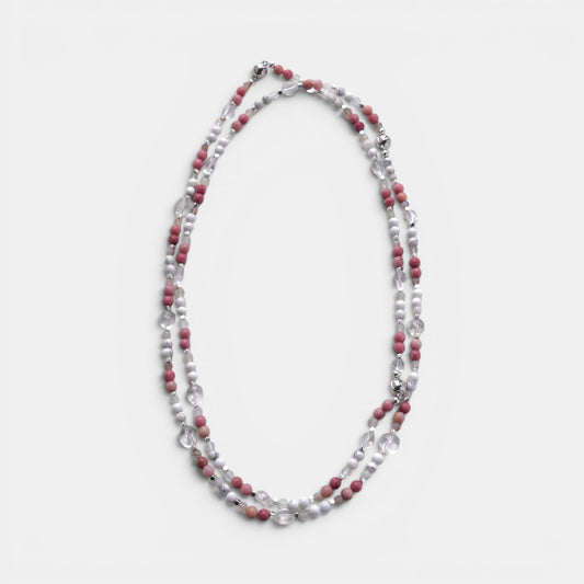 Hollywood Road Stories layered necklace with pink rhodonite, white howlite, and clear crystal beads on a white surface.