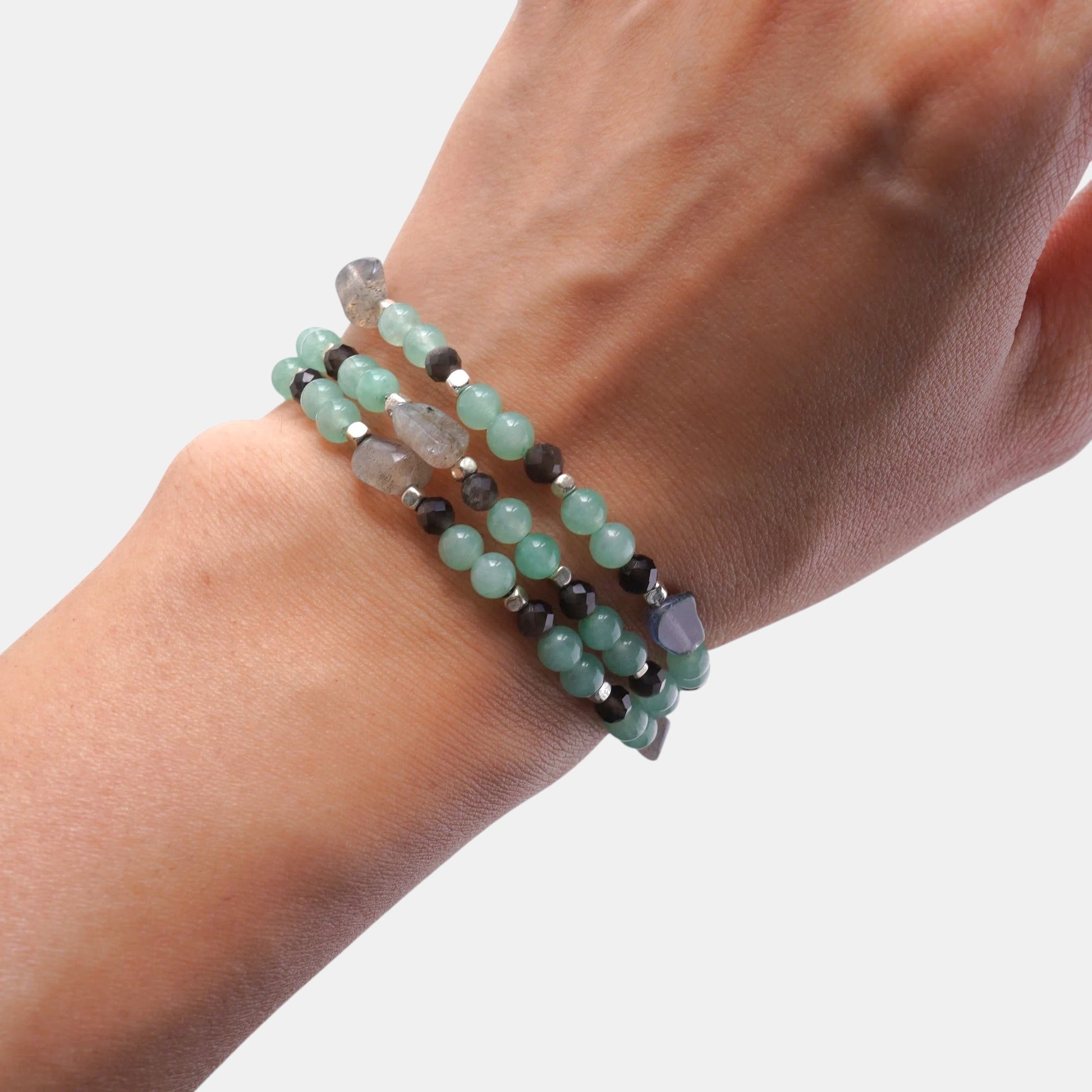 Hollywood Road Stories multi-strand beaded bracelet featuring mint green beads, grey stones, and metallic accents on wrist