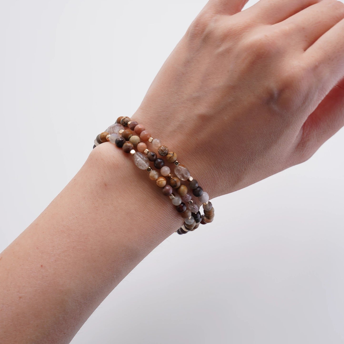 Hollywood Road Stories multi-strand beaded bracelet with terracotta, grey, and cream natural stones on a wrist