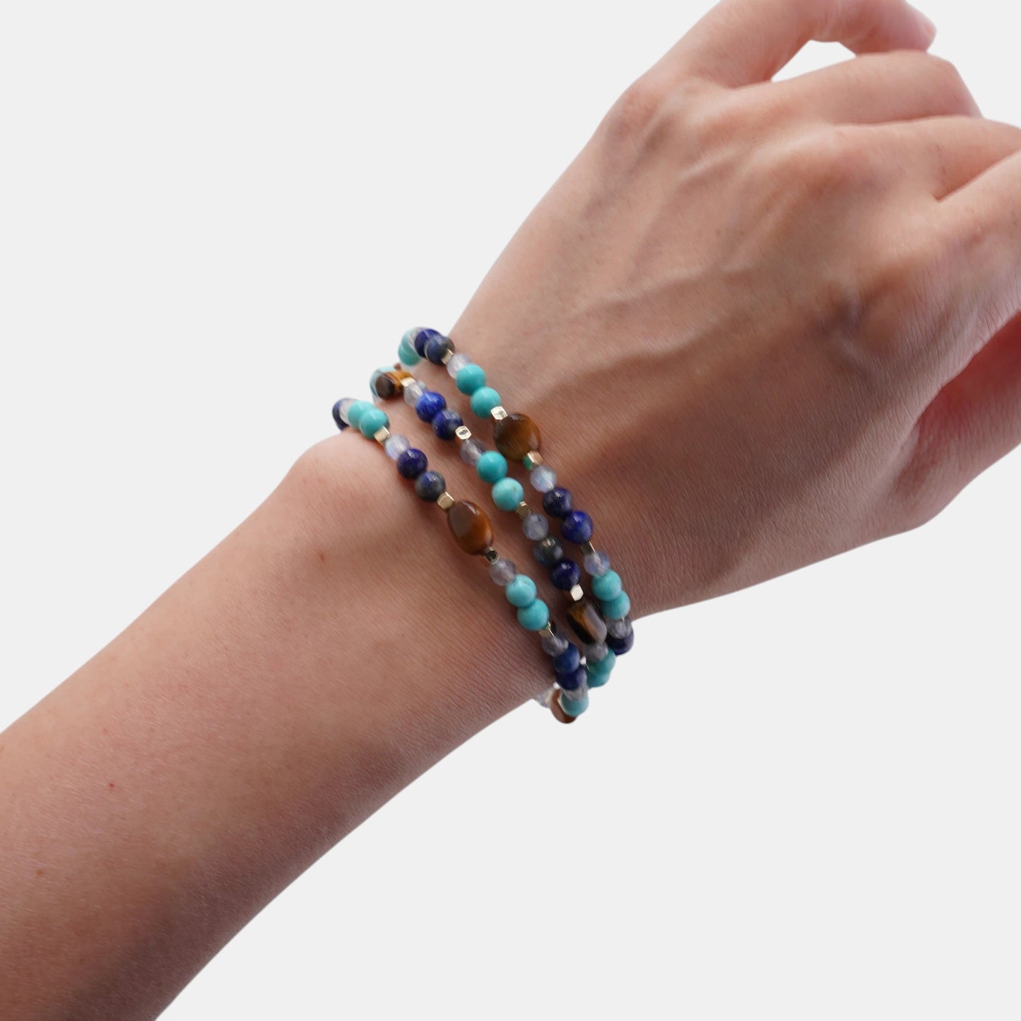 Hollywood Road Stories multi-stone beaded bracelet featuring turquoise, lapis lazuli, and tiger's eye on a wrist.