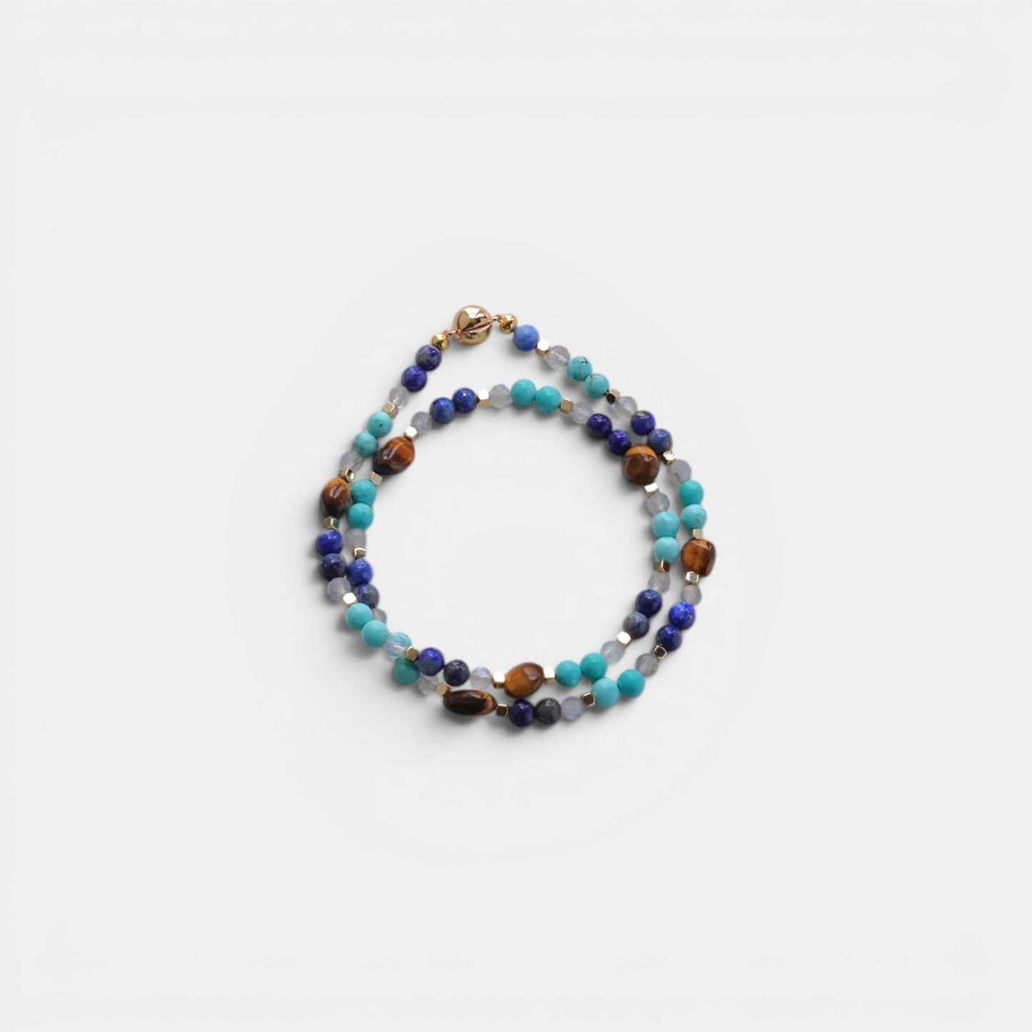 Hollywood Road Stories multi-strand gemstone wrap bracelet with lapis lazuli, turquoise, tiger's eye, and gold spacers.