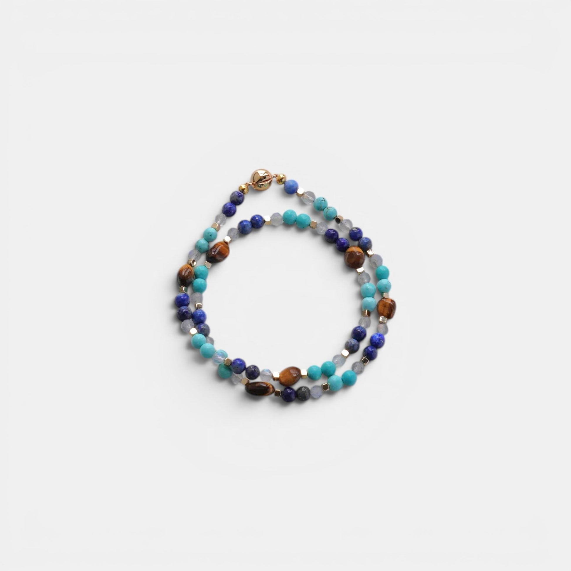 Hollywood Road Stories multi-strand gemstone wrap bracelet with lapis lazuli, turquoise, tiger's eye, and gold spacers.